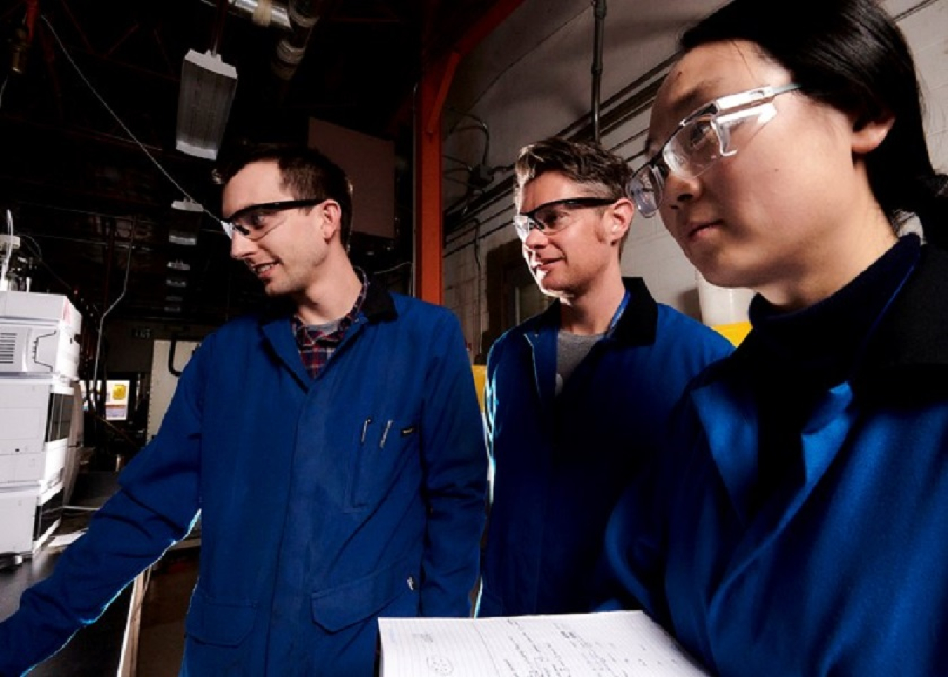 a photo of 3 researchers in a lab