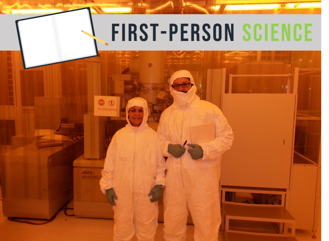 Man and woman in clean room “bunny suits” in front of machinery.