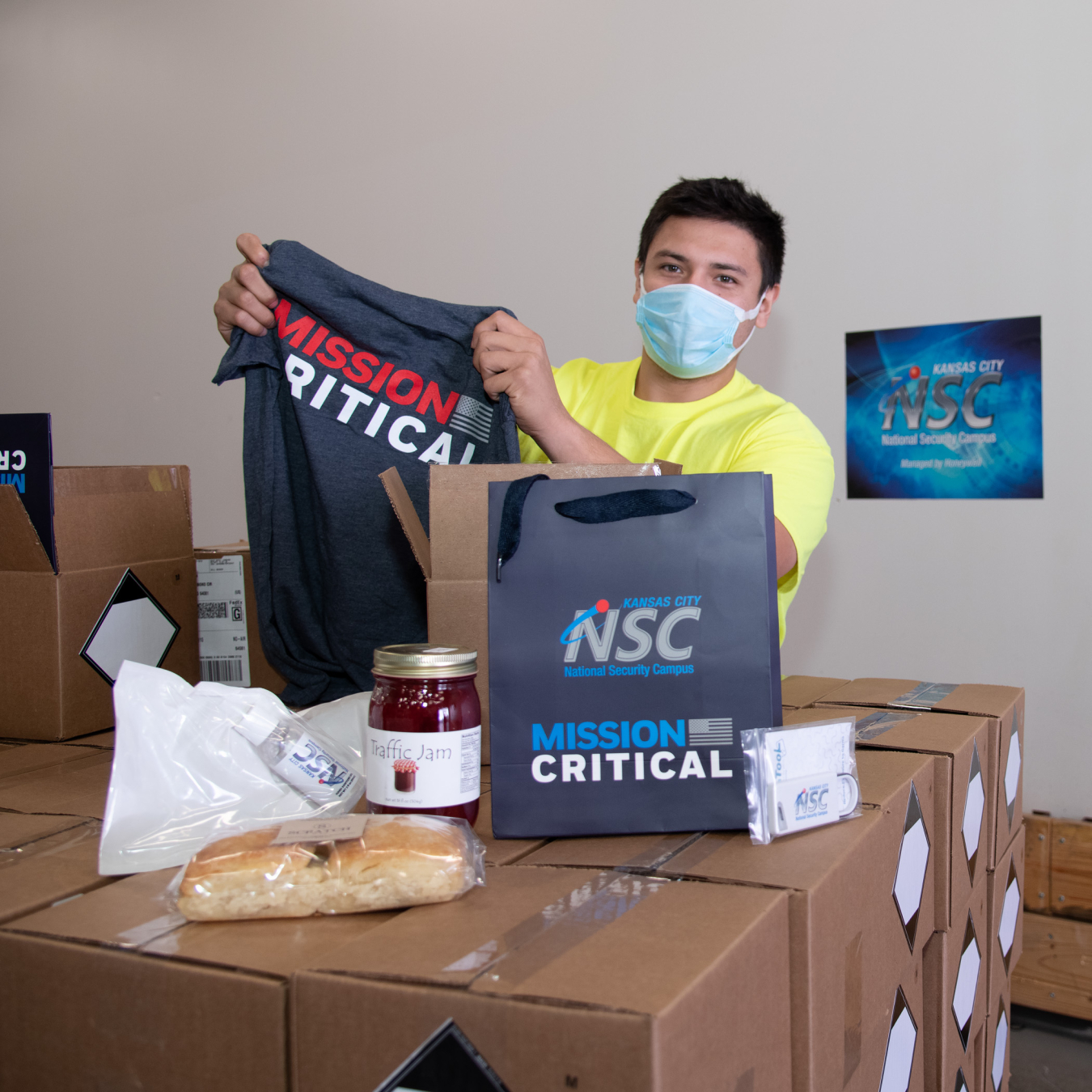 The KCNSC appreciation boxes contain a “mission critical” T-shirt, local farm-fresh jam and biscuits, hand sanitizer, a touchless safety tool, and a personal message from the site’s leadership.