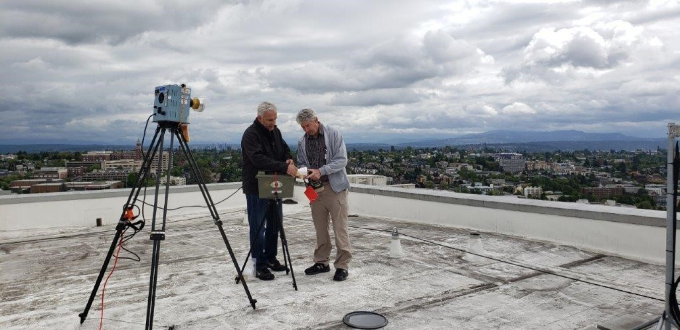 Experts test air samples on the roof of the Research and Training Building at the University of Washington as part of the cleanup process following a cesium breach at the facility.