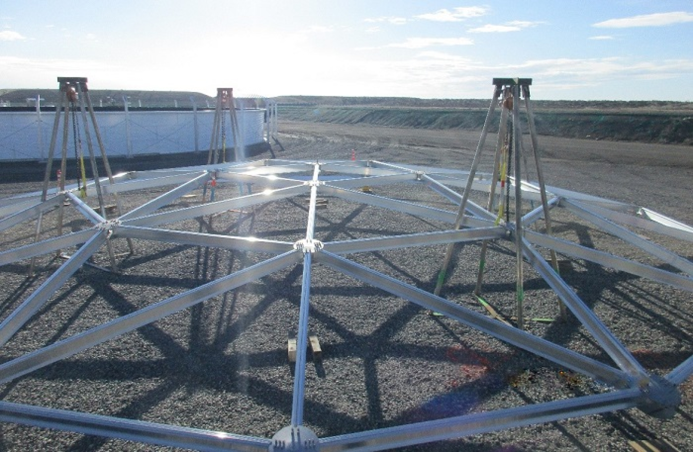 Workers with EM contractor Central Plateau Cleanup Company are constructing domes, or roofs, for two leachate collection tanks at the Integrated Disposal Facility. When operational, the tanks will be used to manage runoff and dust-suppression water collected from the engineered landfill.