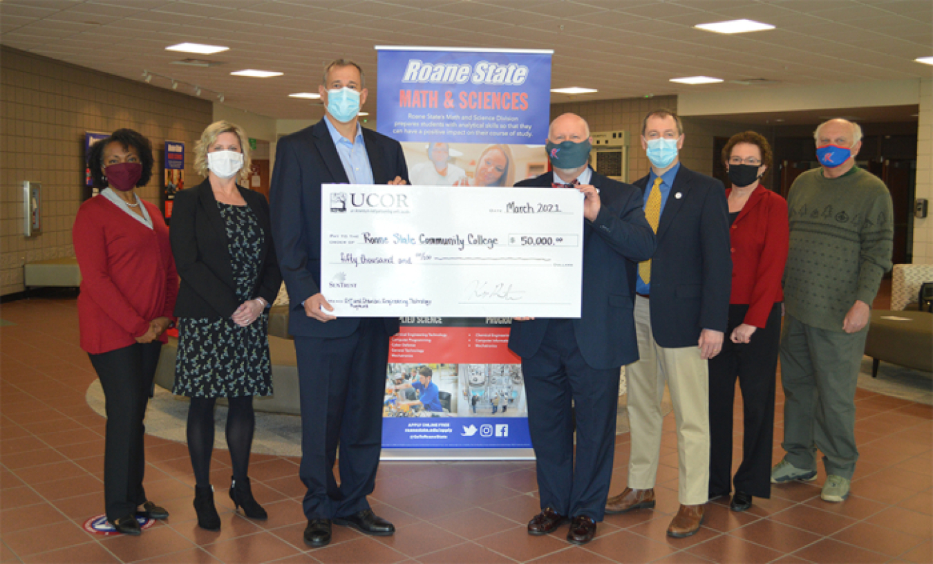 UCOR and Roane State Community College representatives celebrate the company’s $50,000 donation that will be used for a new apprenticeship effort and to purchase equipment for the college’s chemical engineering technology laboratory.