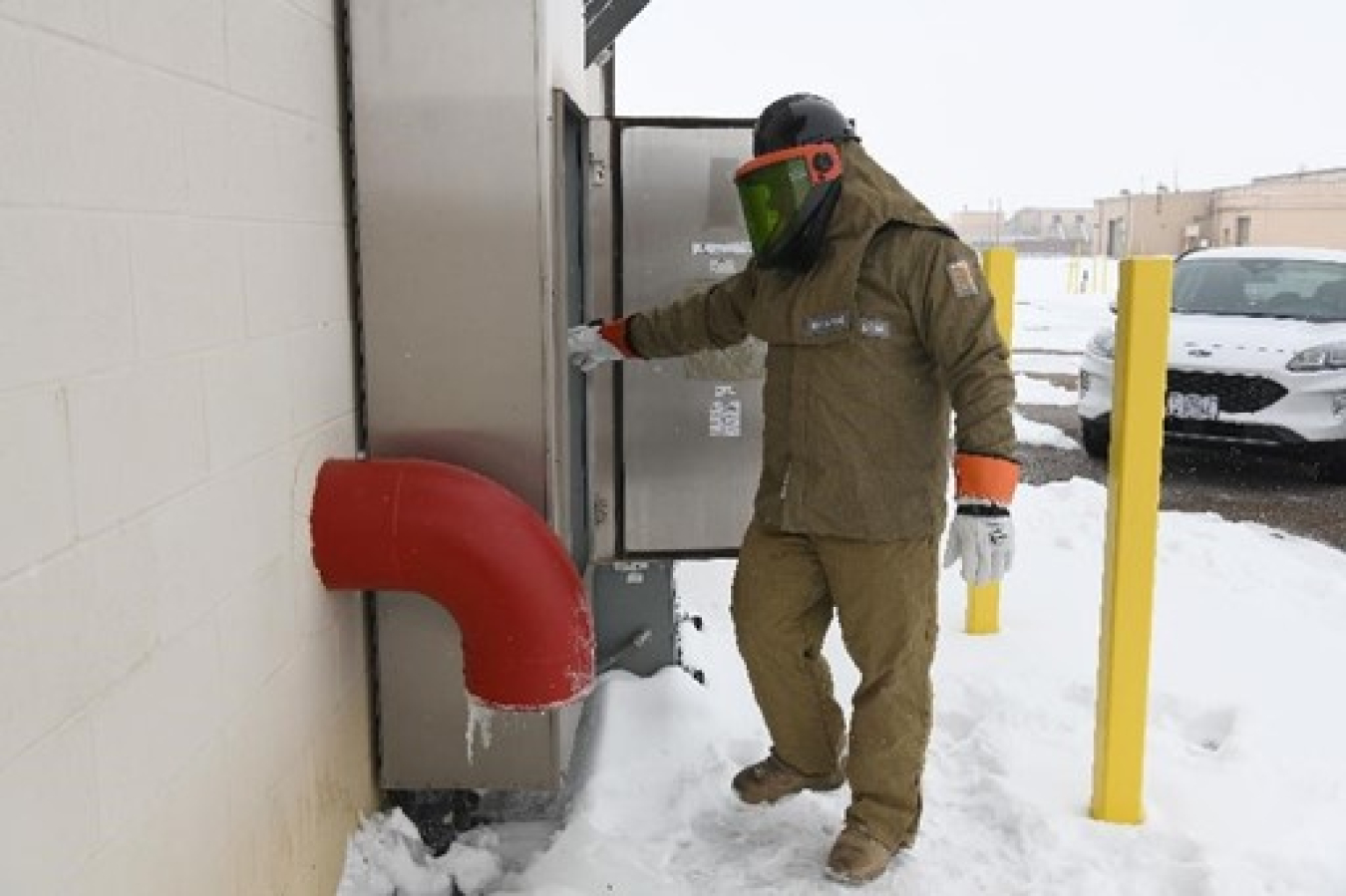 A Pantex electrician inspects connections related to the High Pressure Fire Loop tank heater.