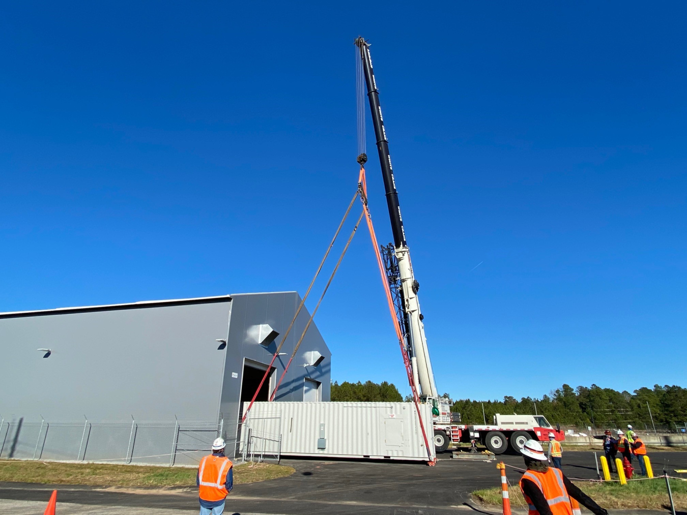 Crews move equipment used to inspect drums holding radioactive material into a storage site in K Area at the Savannah River Site. 