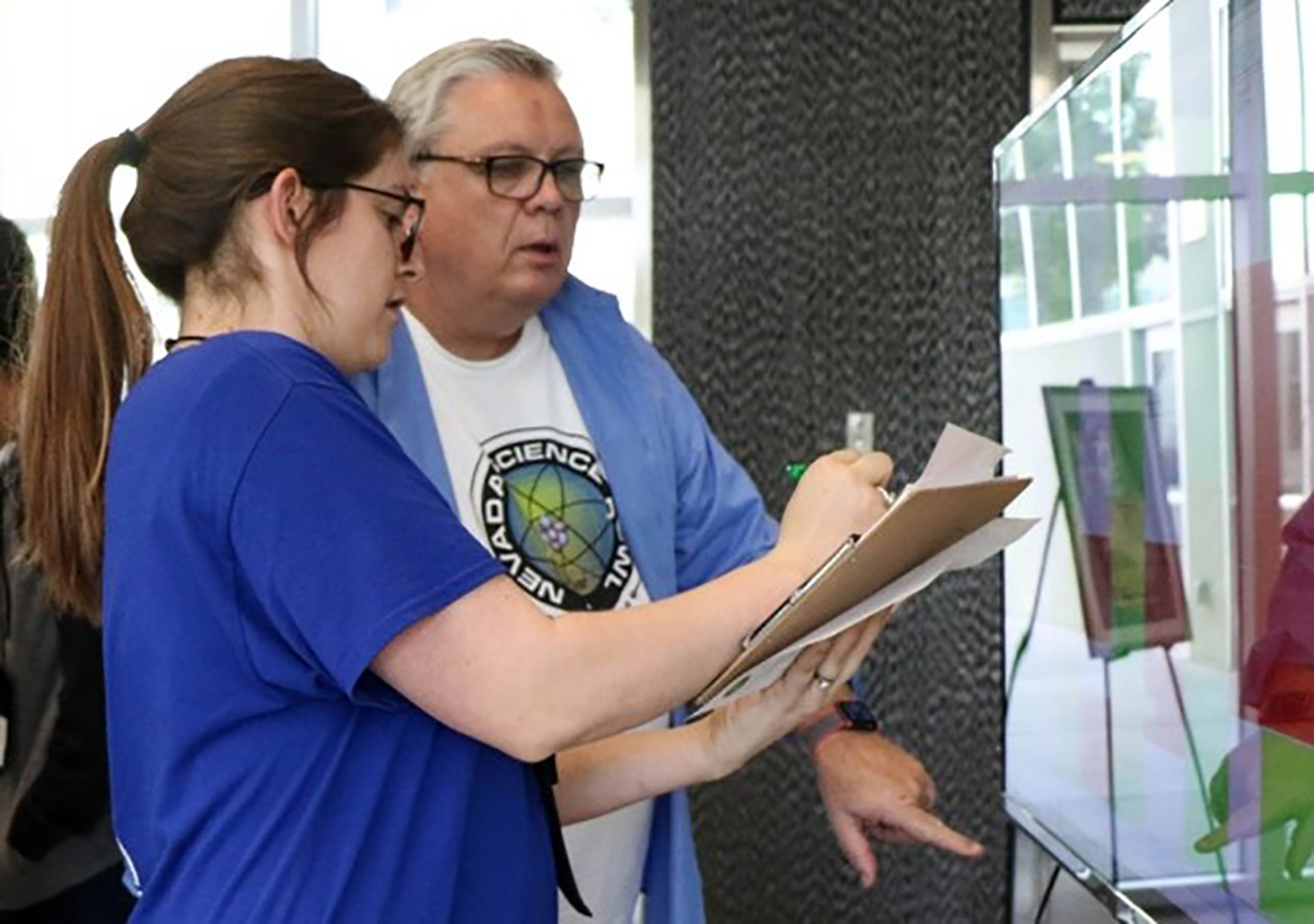 Darwin Morgan working alongside NNSS's Kayla Buchanan during the Nevada Science Bowl in February 2018.