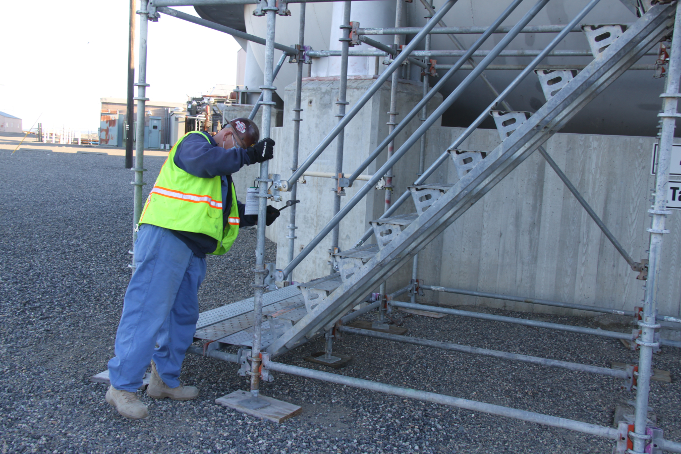 Bryce Young with Hanford Mission Integration Solutions inspects scaffolding prior to divers scaling a large water tank and descending into the water on a ladder to inspect the tank’s interior. The success of the complex inspections involved teams from multiple contractors and crews, reinforcing the value of a collaborative approach.