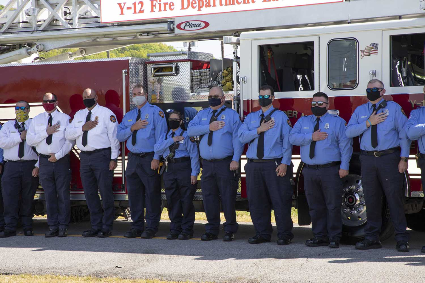 Y-12 firefighters hold their hands over their hearts during the ceremony.