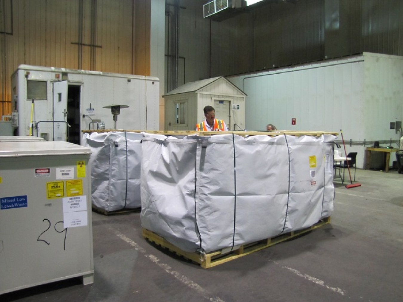 Bruno Zovi, Fluor Idaho waste disposal and waste generator services manager, inspects a waste shipment before it is loaded on a tractor trailer for disposal at an off-site facility.