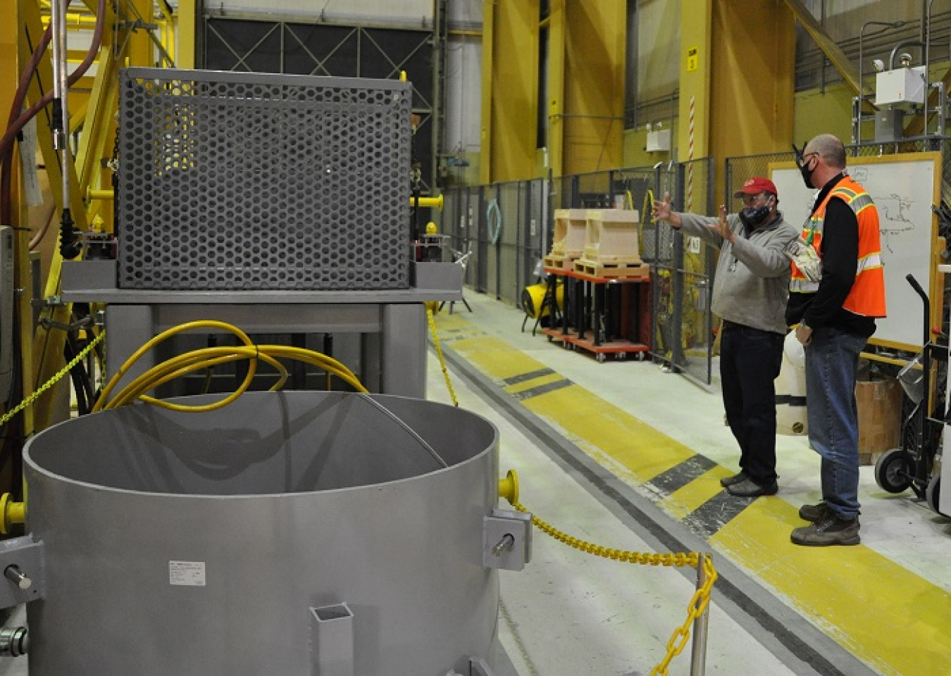 Ray Geimer with EM contractor Central Plateau Cleanup Company, left, shows company president Scott Sax a mock-up of parts of a vertical pipe casing system at Hanford’s Maintenance and Storage Facility. The system will be used to stabilize and remove radioactive debris at Hanford’s 1.2-million-gallon K West Reactor fuel storage basin.