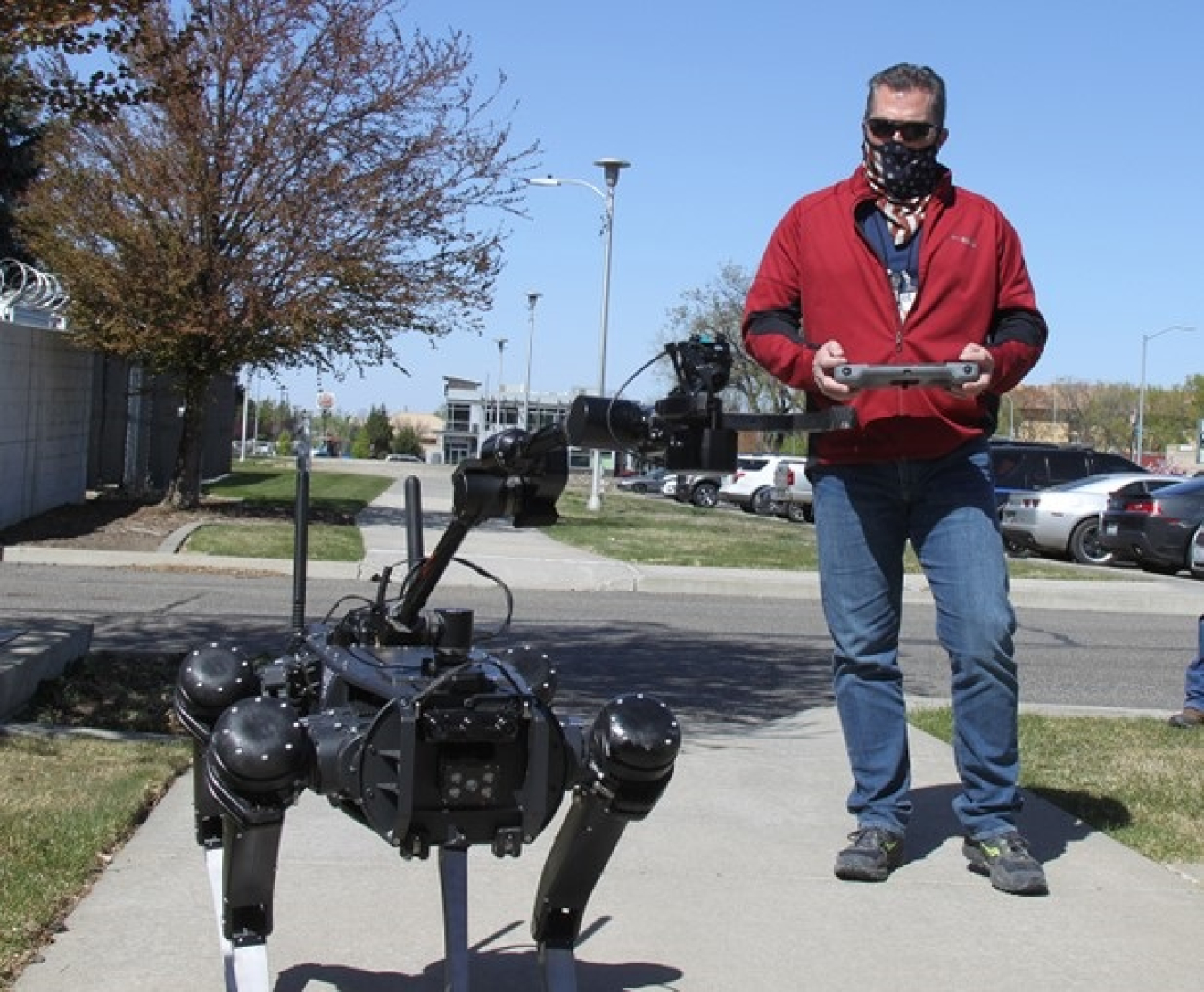 Taking the “dog” for a walk: Central Plateau Cleanup Company Radiation Area Remedial Action Manager Roy Plunkett tries his hand at the controls of a four-legged, remotely operated robot that aims to improve worker safety and increase productivity at Hanford.