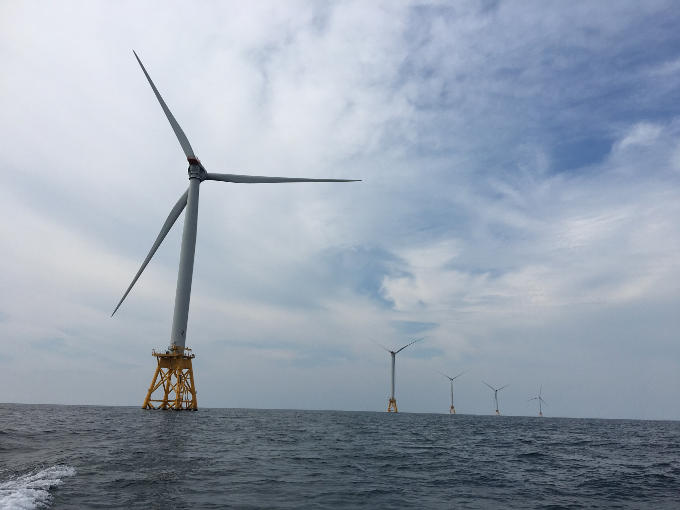 Photo of offshore wind turbines in the ocean at the Block Island Wind Farm.