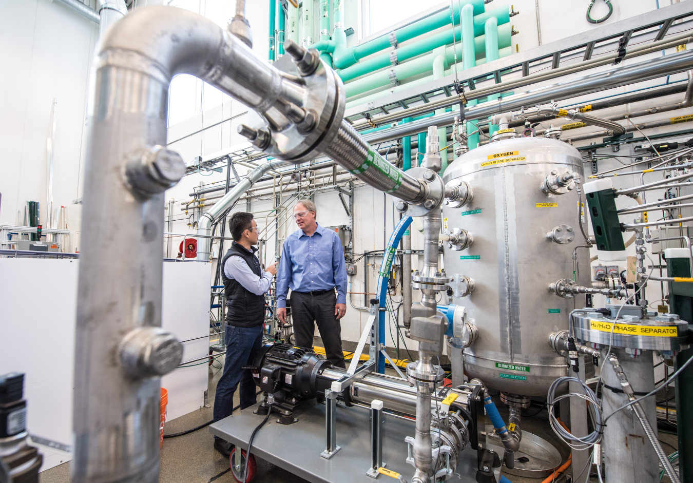 Two men stand in a laboratory.