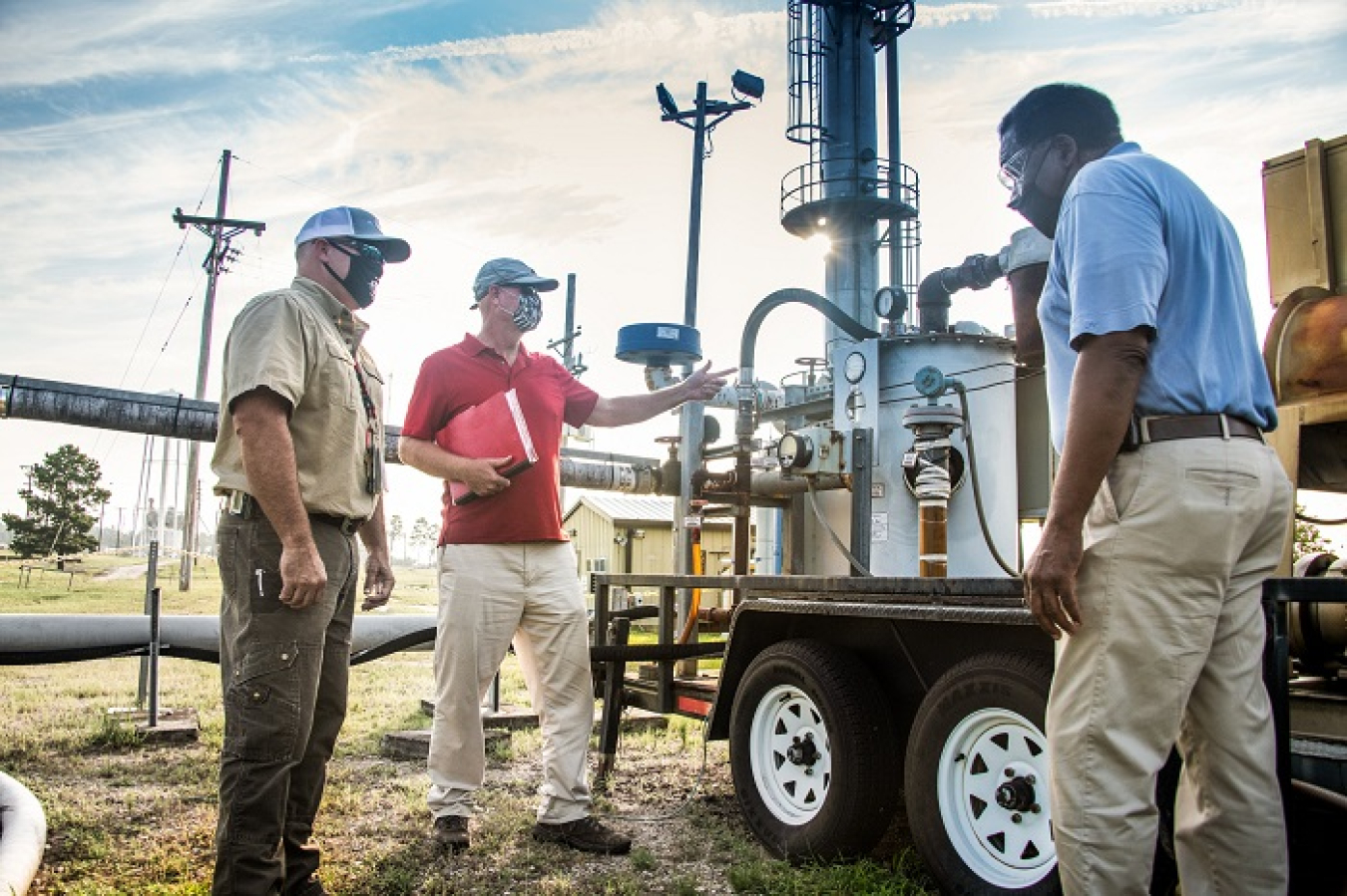 From left, Savannah River Nuclear Solutions (SRNS) mechanic Todd Cockrell, engineer John Bradley, and project manager Joao Cardoso-Neto plan the removal and dismantlement of a high-vacuum soil vapor extraction unit at the Savannah River Site. SRNS was one of two major contractors at the site to receive high marks for their environmental management system. 