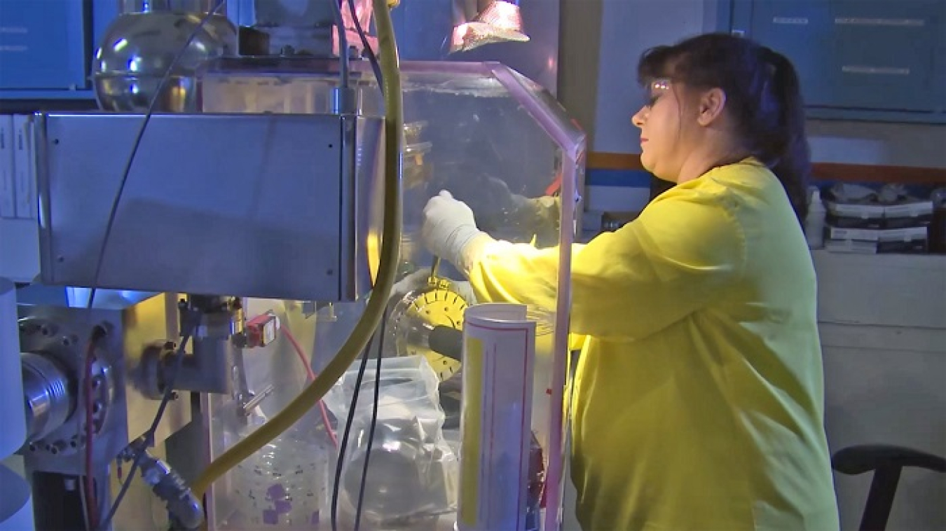 Savannah River Nuclear Solutions First Line Manager Nancy Norris loads material into a mass spectrometer for analysis at the Savannah River Site.