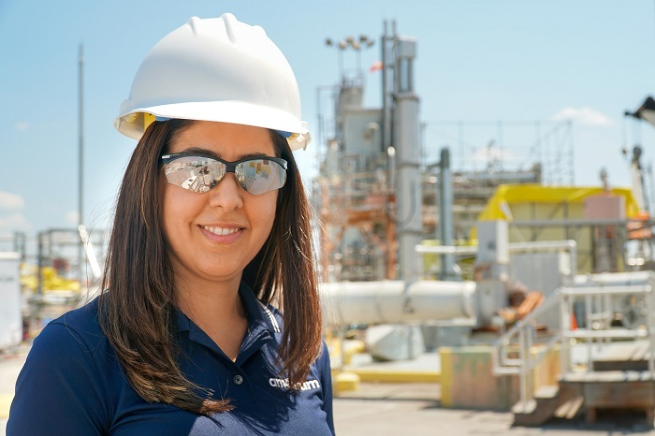 Savannah River Remediation Principal Engineer Azadeh Samadi-Dezfouli, pictured in front of a salt waste blend tank, manages salt and sludge batch qualification activities and schedules at the Savannah River Site to ensure batch qualification and delivery are timely.