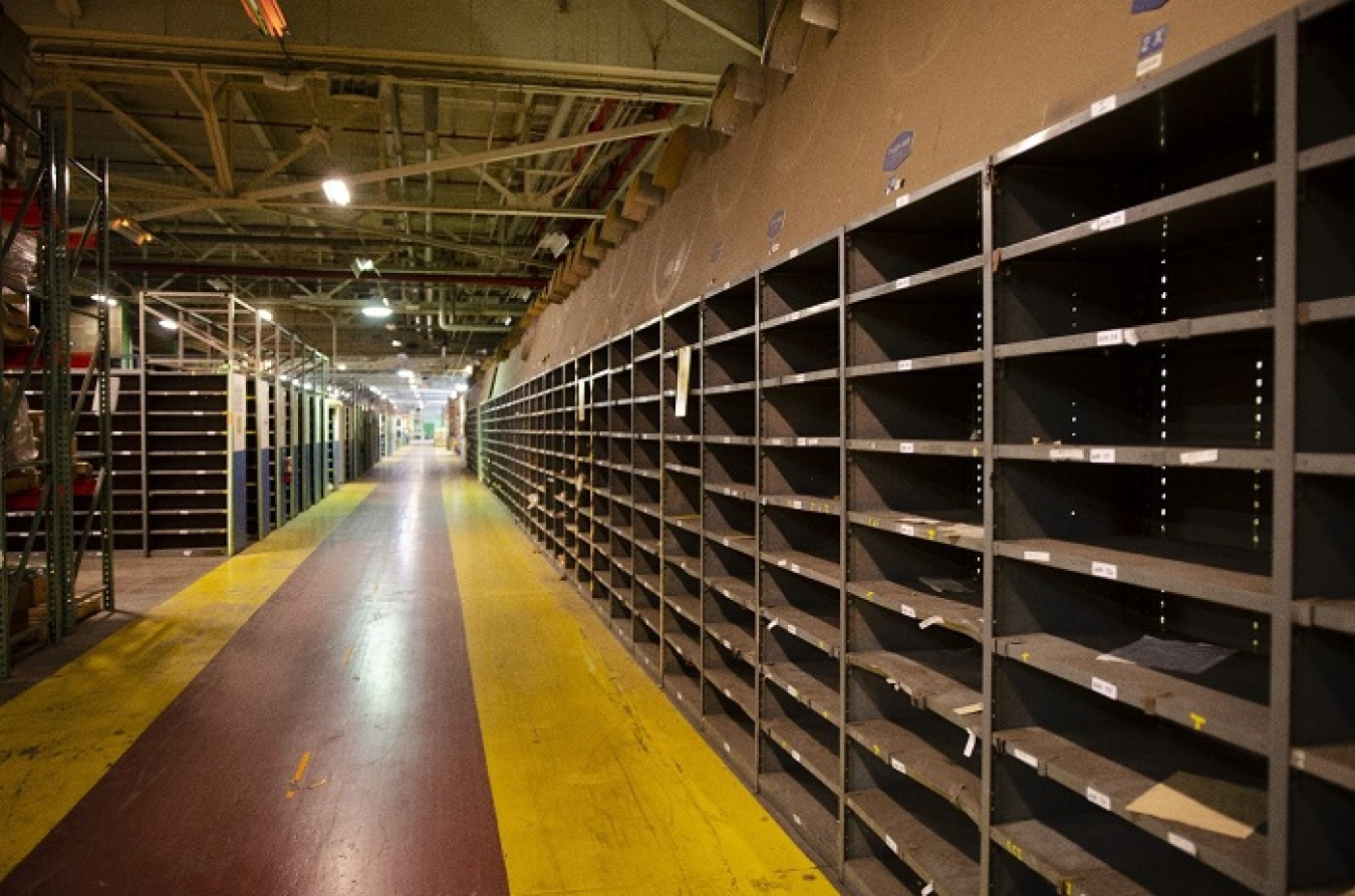 Approximately 90,000 square feet of stores operations space, equivalent to the size of a city block, was relocated from the C-720 Maintenance and Storage Building to a smaller facility. Pictured here are empty shelves where supplies and inventory were once organized at C-720. 