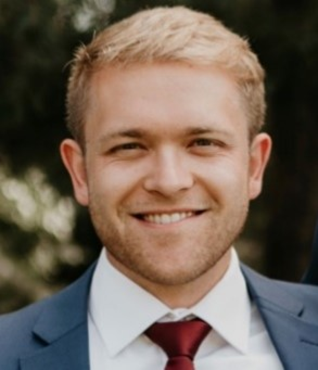 Headshot of a male smiling.