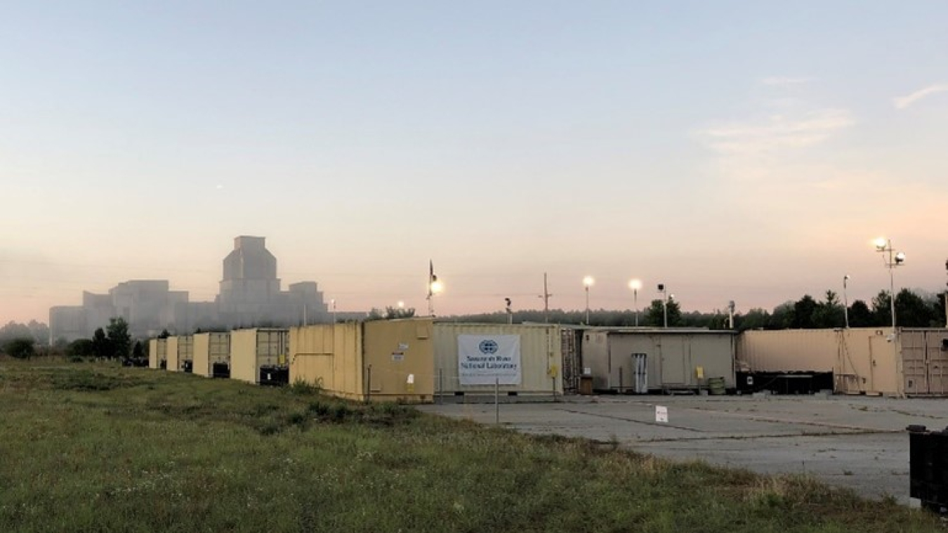 The Mobile Plutonium Facility during Relentless Rook at the Savannah River Site with P Reactor in background.