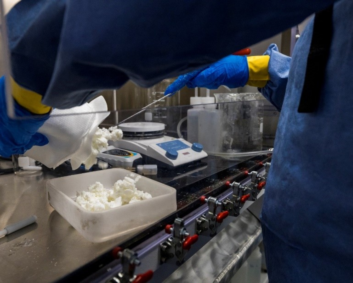 Mobile Uranium Facility fissile material handlers preparing simulated precipitate for drying.