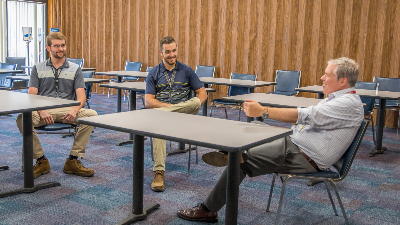 Jim Alpers, left, a senior chemical engineering student at Texas Tech University, and Will Fiala, a senior mechanical engineering and economics student from the University of New Mexico, meet with EM Acting Assistant Secretary William "Ike" White during his visit to the Waste Isolation Pilot Plant.