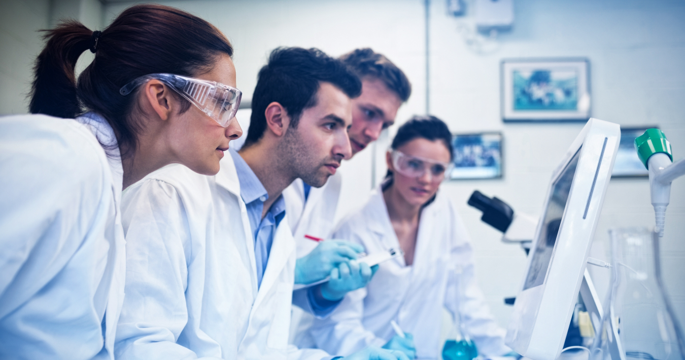 Lab Researchers Running and Monitoring Test Data on Computer Screen