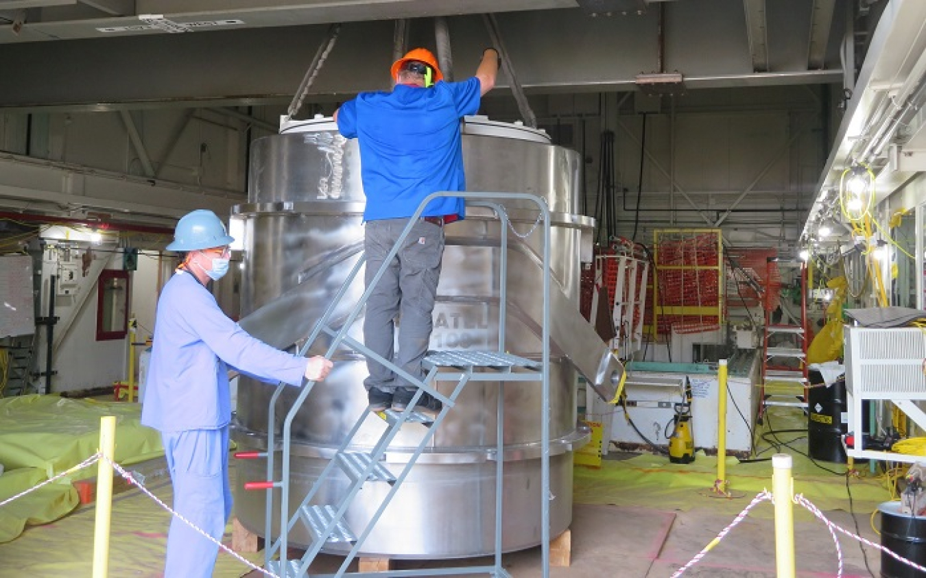 Employees at Oak Ridge place a waste disposal liner into an 88,000-pound transportation cask to safely ship irradiated materials from a reactor pool offsite for disposal.