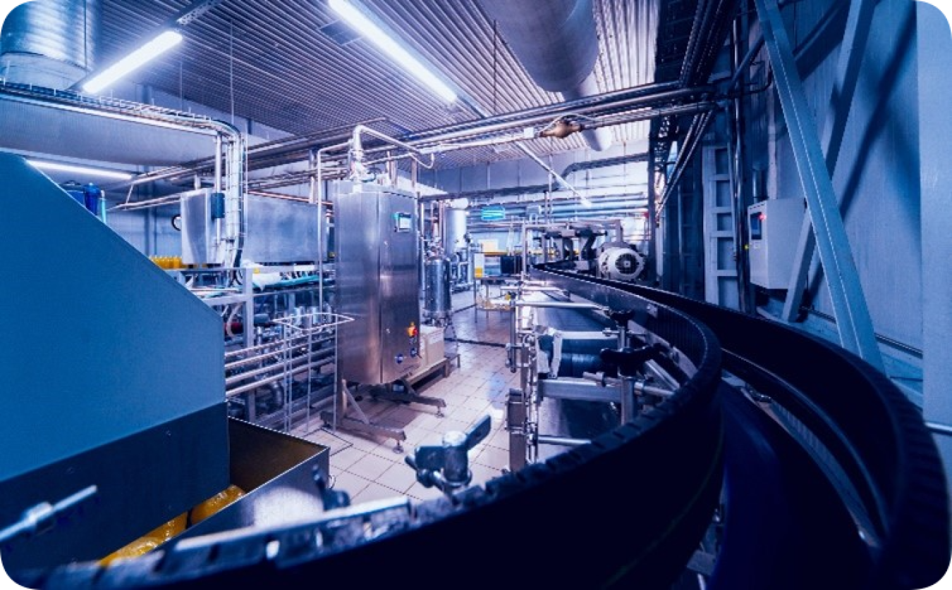 a photo from inside a manufacturing facility, with a long conveyer belt.