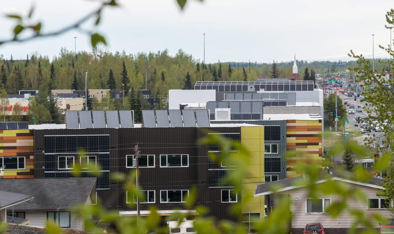 A photo of several buildings in an urban area with solar panels on the roofs