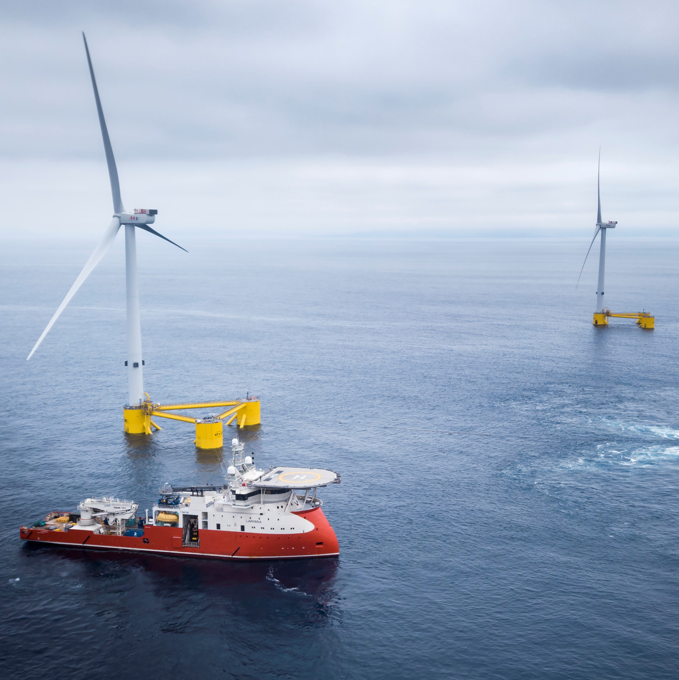 Offshore wind turbines and a boat at sea.