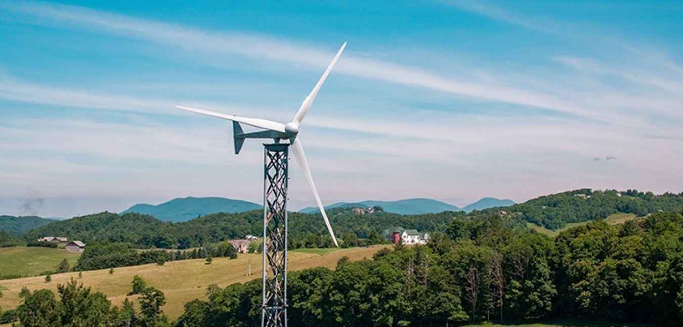 Distributed wind turbine with mountains in the background.