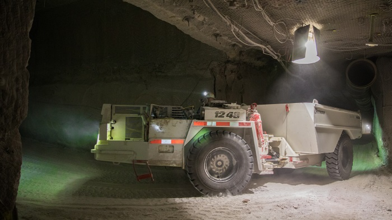 A salt haul truck turns a corner into Panel 8 in the Waste Isolation Pilot Plant underground. The haul trucks take salt from a continuous miner machine in Panel 8 to a salt hoist for transport to the surface. Panel 8 mining, recently completed, totaled more than 157,000 tons of mined salt.