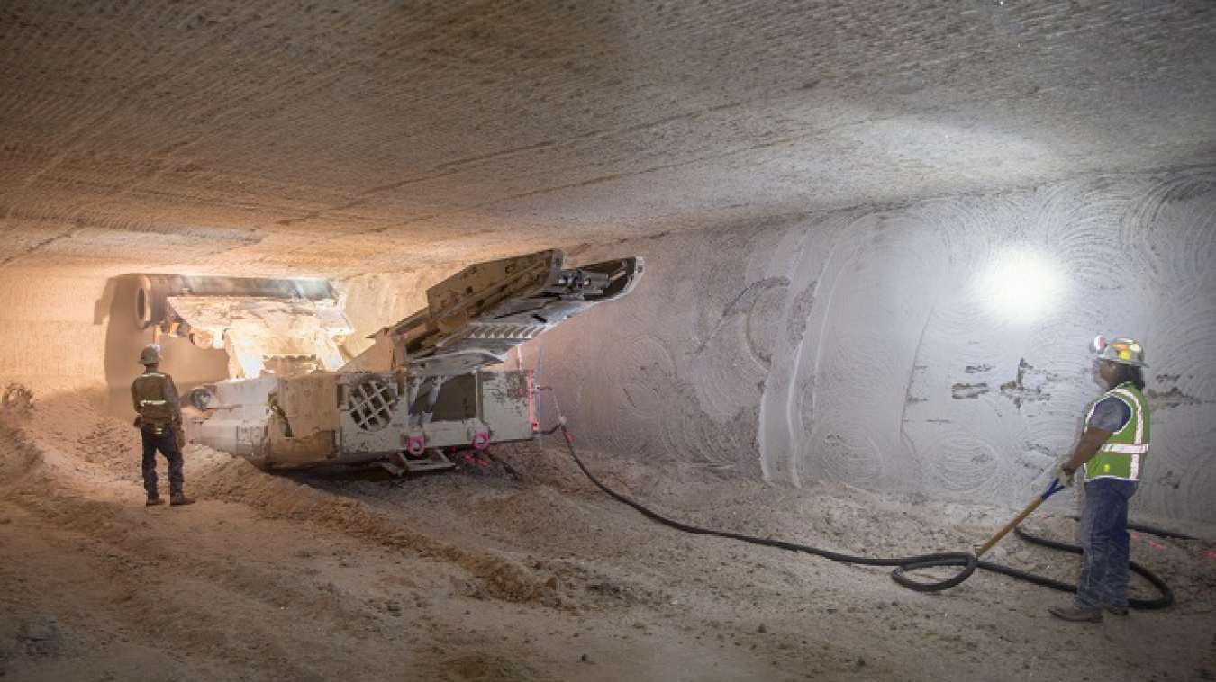 An electric continuous miner machine run by Waste Isolation Pilot Plant underground miners Randy Wilson, left, and Blas Castaneda chews through the last wall of salt in Panel 8’s Room 7 to complete the rough cut of the panel. The rough cut completes the dimensions of the panel; another pass lowered the floor to create the room’s final height of 15 feet.