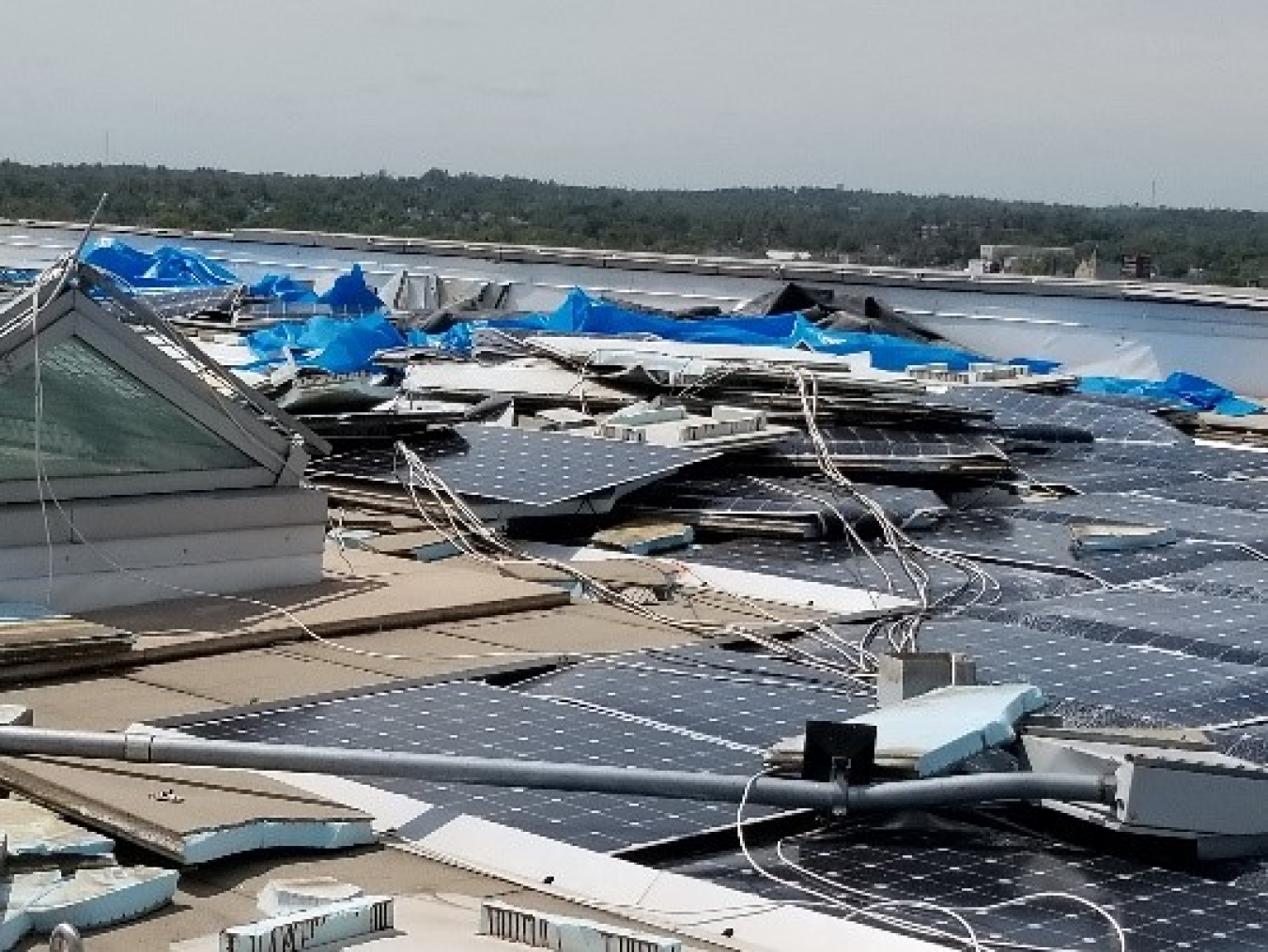 A roof-mounted PV array damaged during a 2020 derecho event. 