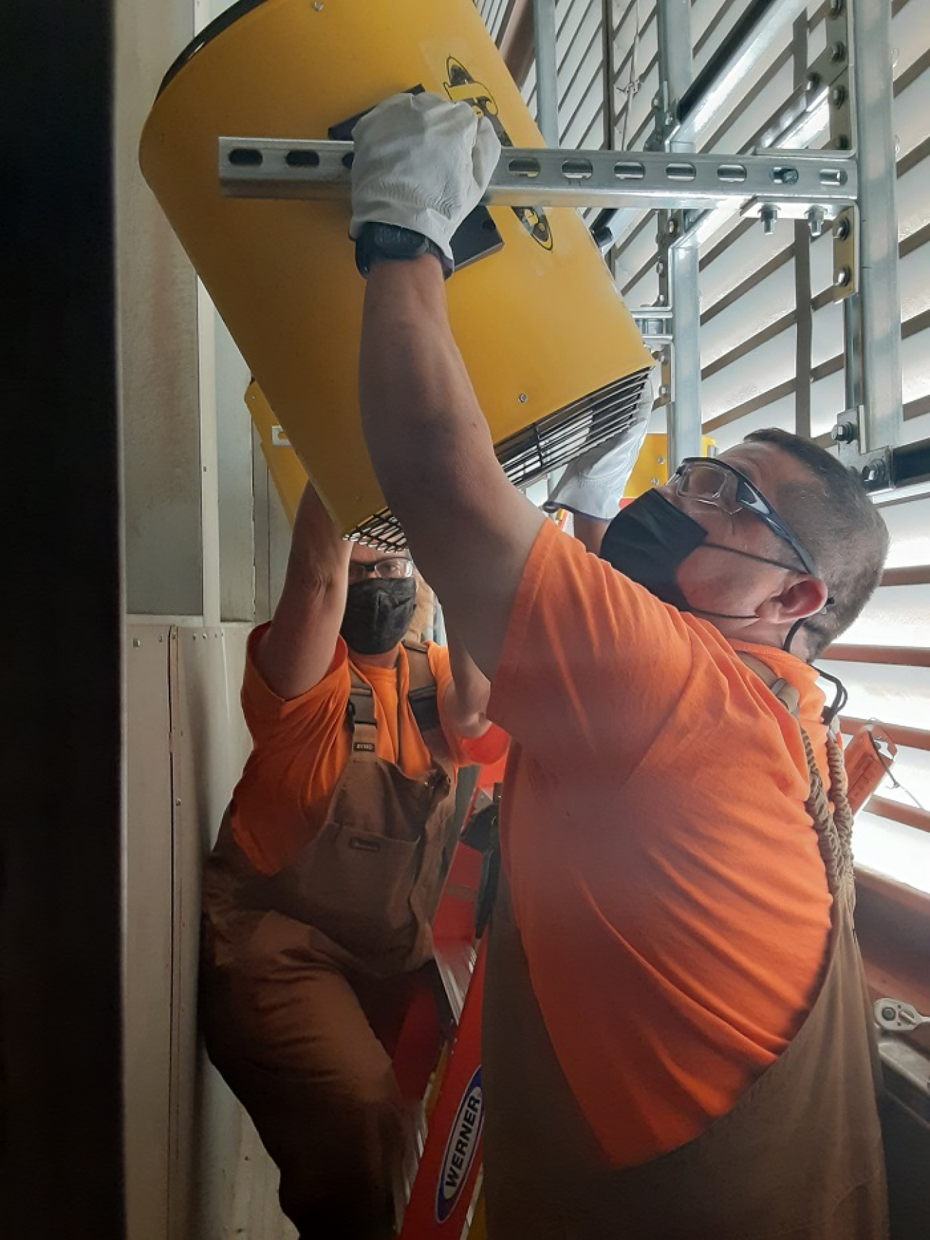 Workers with EM contractor Central Plateau Cleanup Company install electric heaters at the 324 Building at the Hanford Site. The heaters will provide a temperature-controlled environment to allow cleanup progress to continue through the winter.