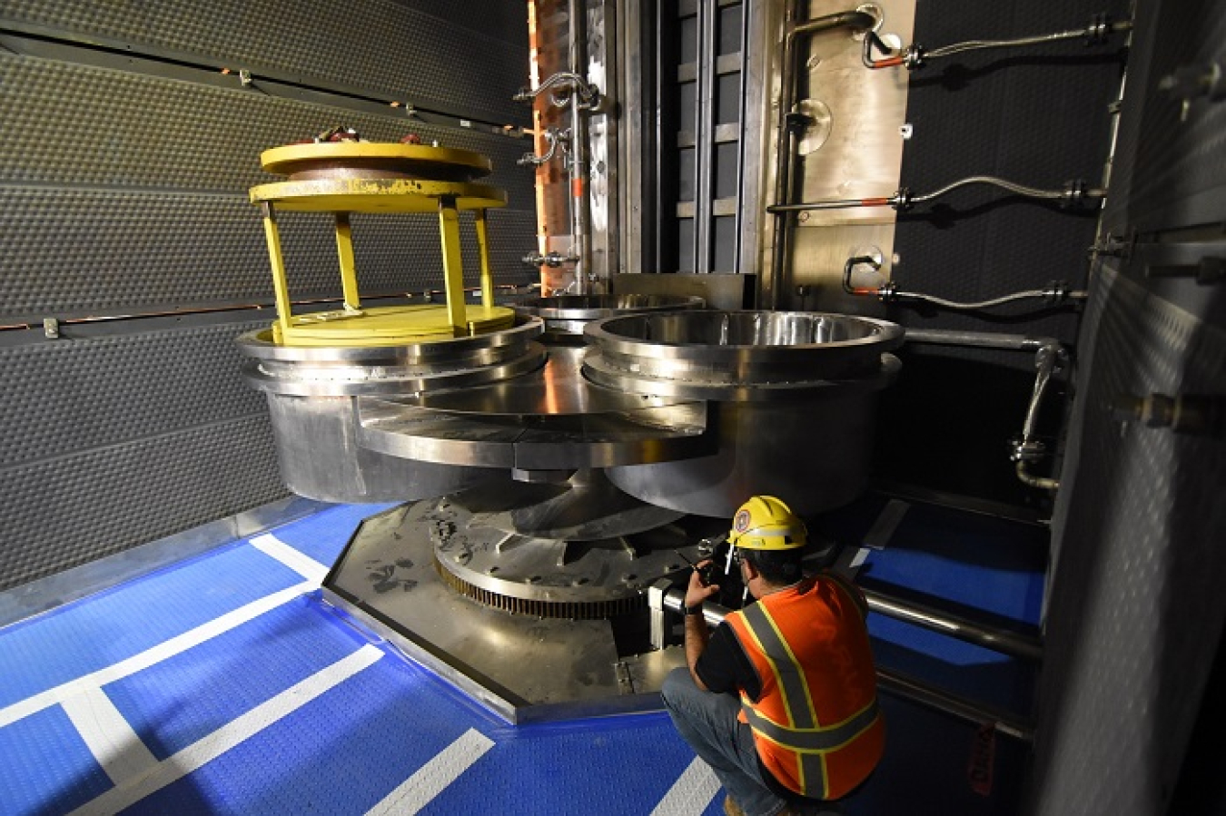 An engineer conducts tests on the turnstiles inside the pour caves of the Low-Activity Waste Facility at the Hanford Site. The turnstiles will hold three stainless steel containers into which vitrified waste will be poured during operations.