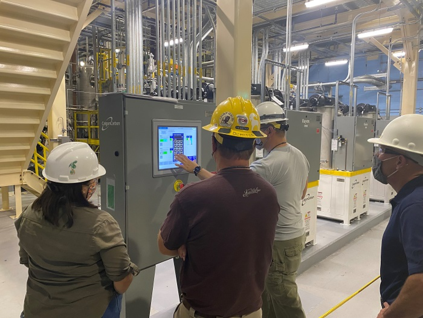 Workers for tank operations contractor Washington River Protection Solutions adjust the initial flow of water through the Effluent Treatment Facility’s new ultraviolet oxidation unit during operation acceptance testing. The new system is part of upgrades to support Hanford’s Direct-Feed Low-Activity Waste Program. 