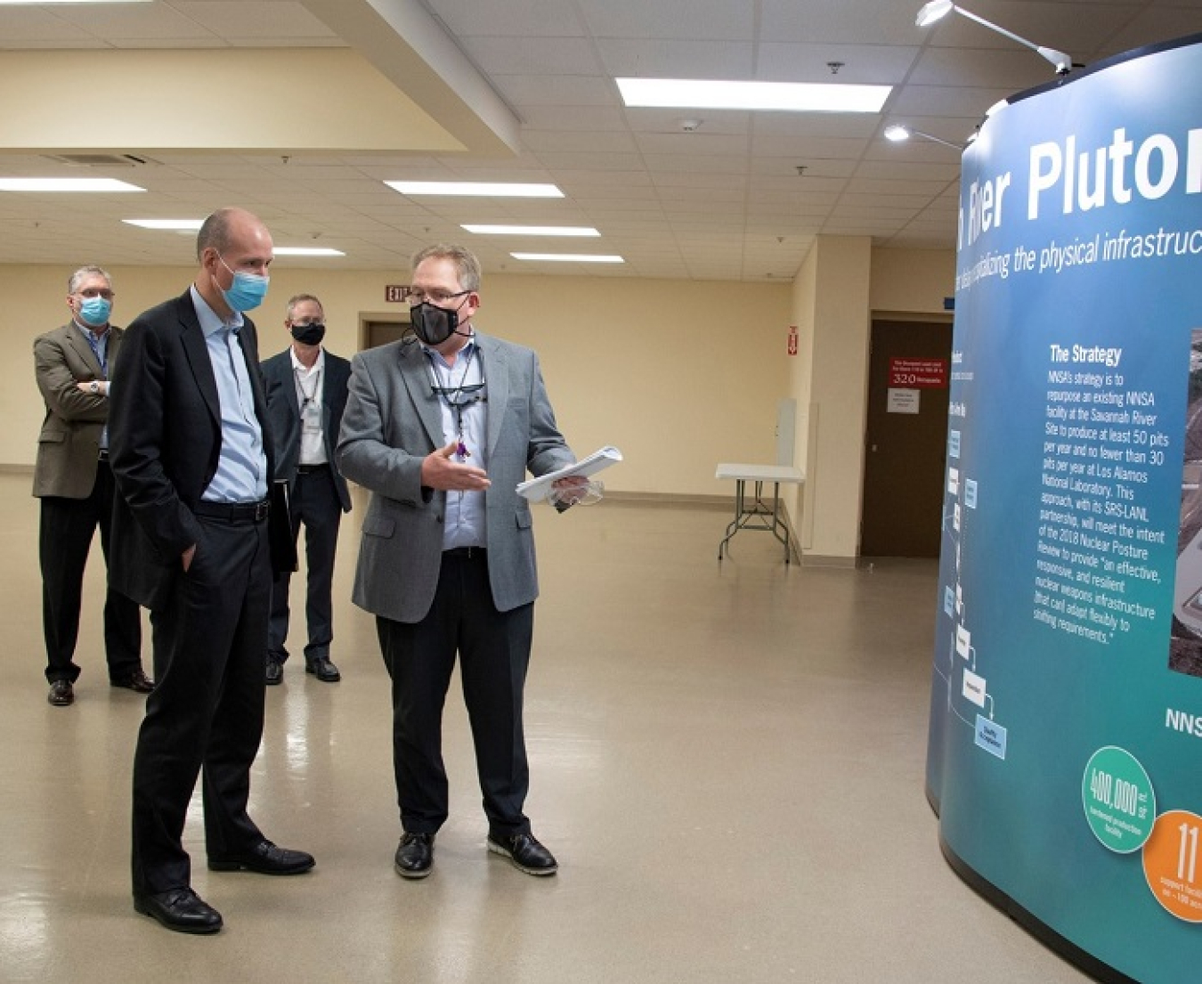 Also pictured are Savannah River Nuclear Solutions President and CEO Stuart MacVean, behind Turk at left, and NNSA Savannah River Acquisition and Project Management Office Deputy Director Bob Leugemors. 