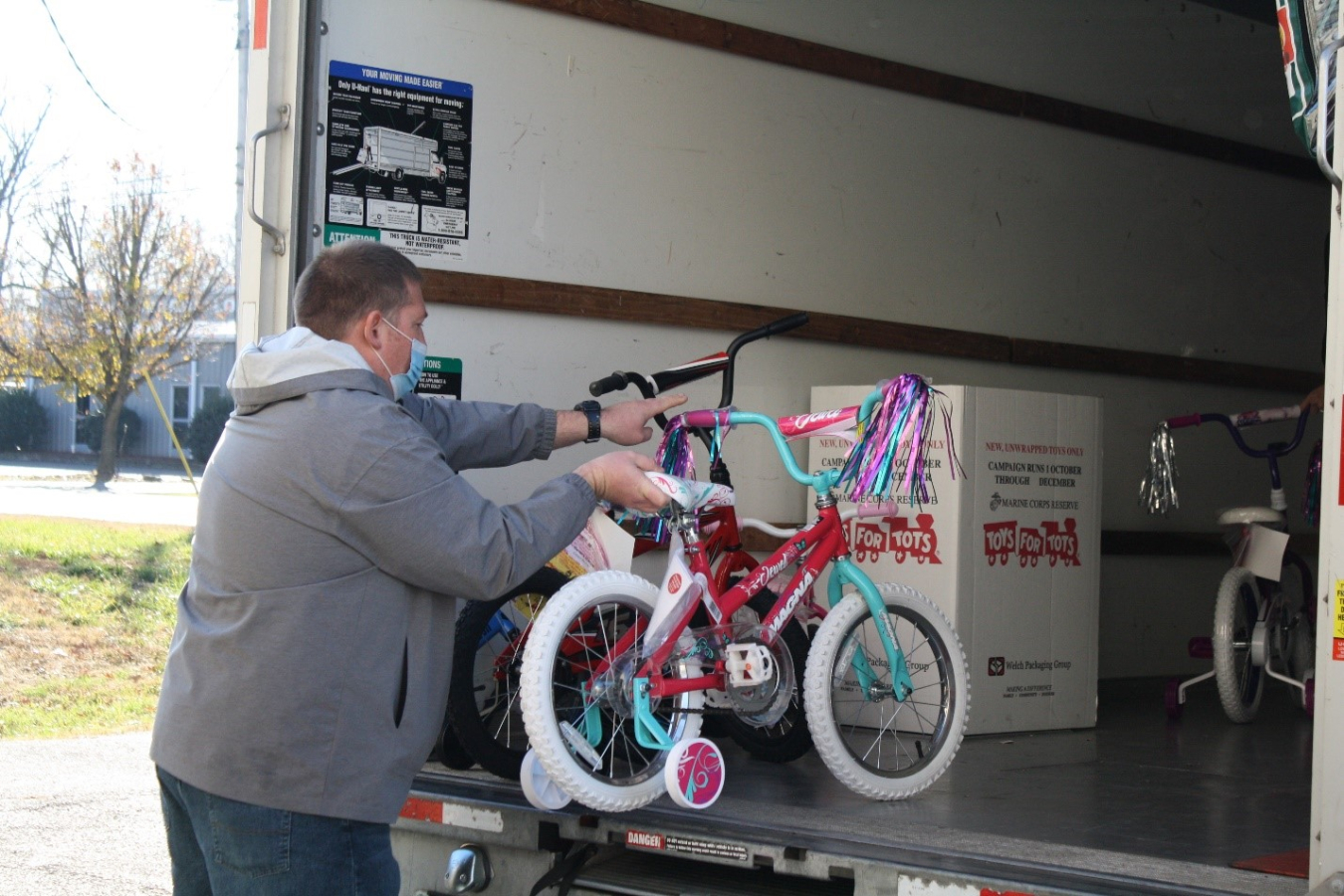 Four Rivers Nuclear Partnership and USW Local 550's Nick Suiter loads one of many bicycles donated for Paducah Toys for Tots.