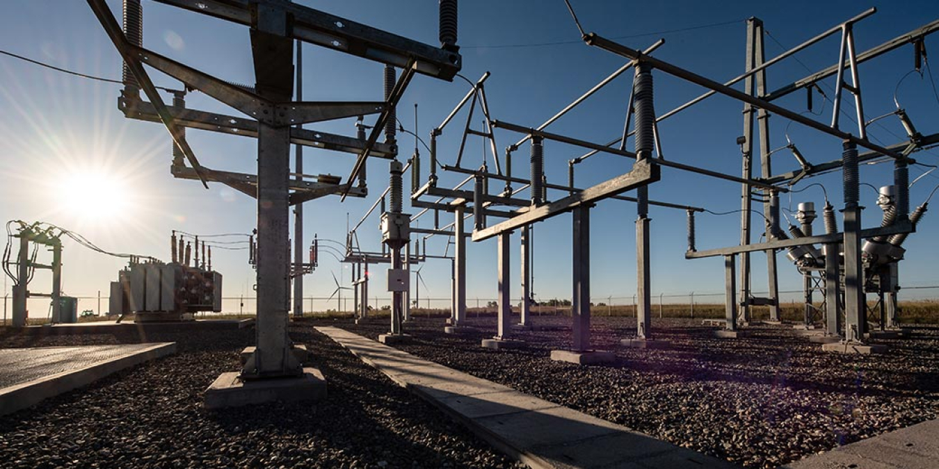 19.9-MW substation in front of a glaring sun and clear blue sky.