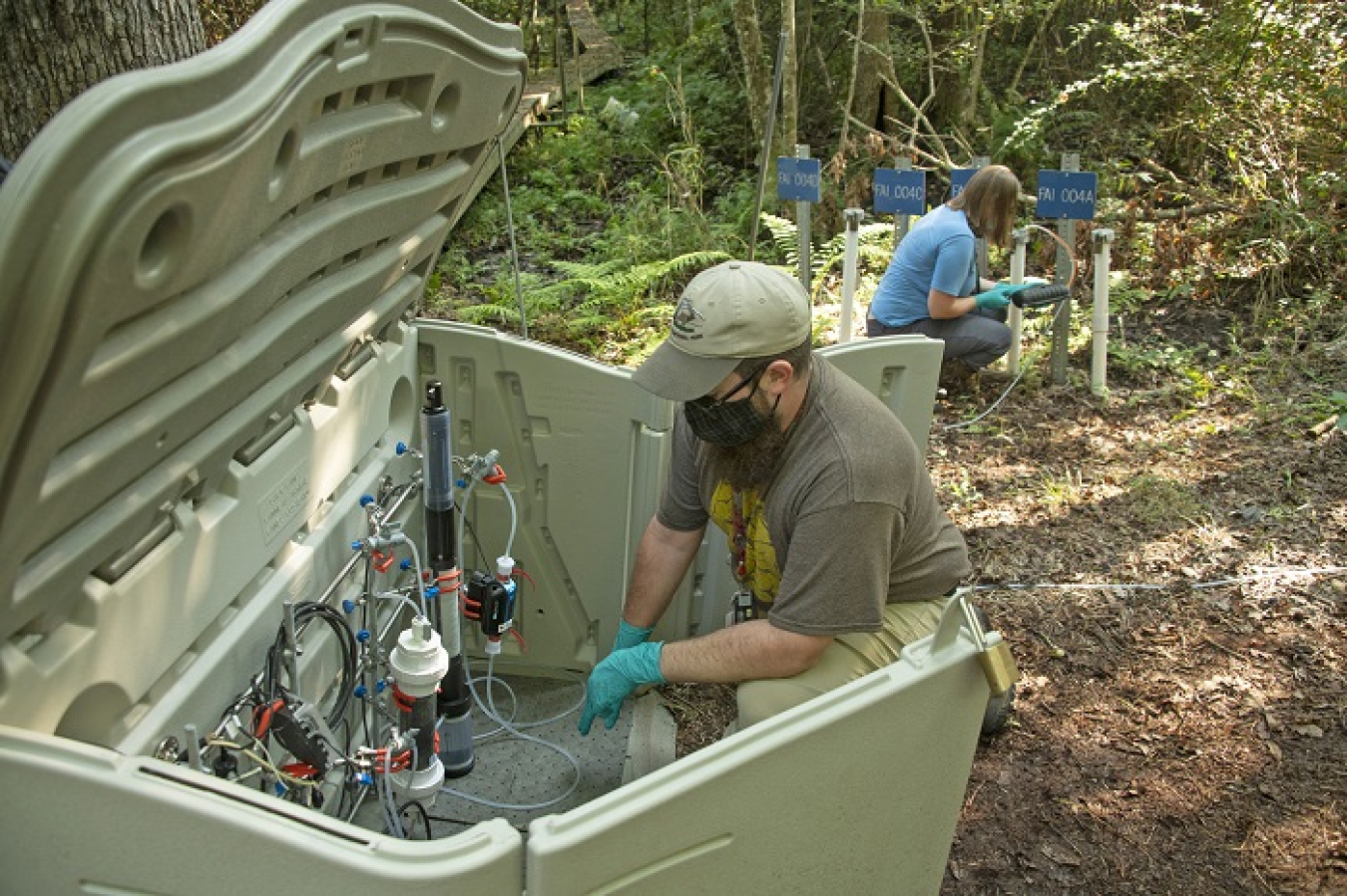 Savannah River Ecology Laboratory soil scientists Jeffrey Lott, left, and Christina Logan monitor experimental test equipment used to remove iodine-129 from groundwater at the Savannah River Site. The equipment is part of a one-of-a-kind system developed at the site for this study.