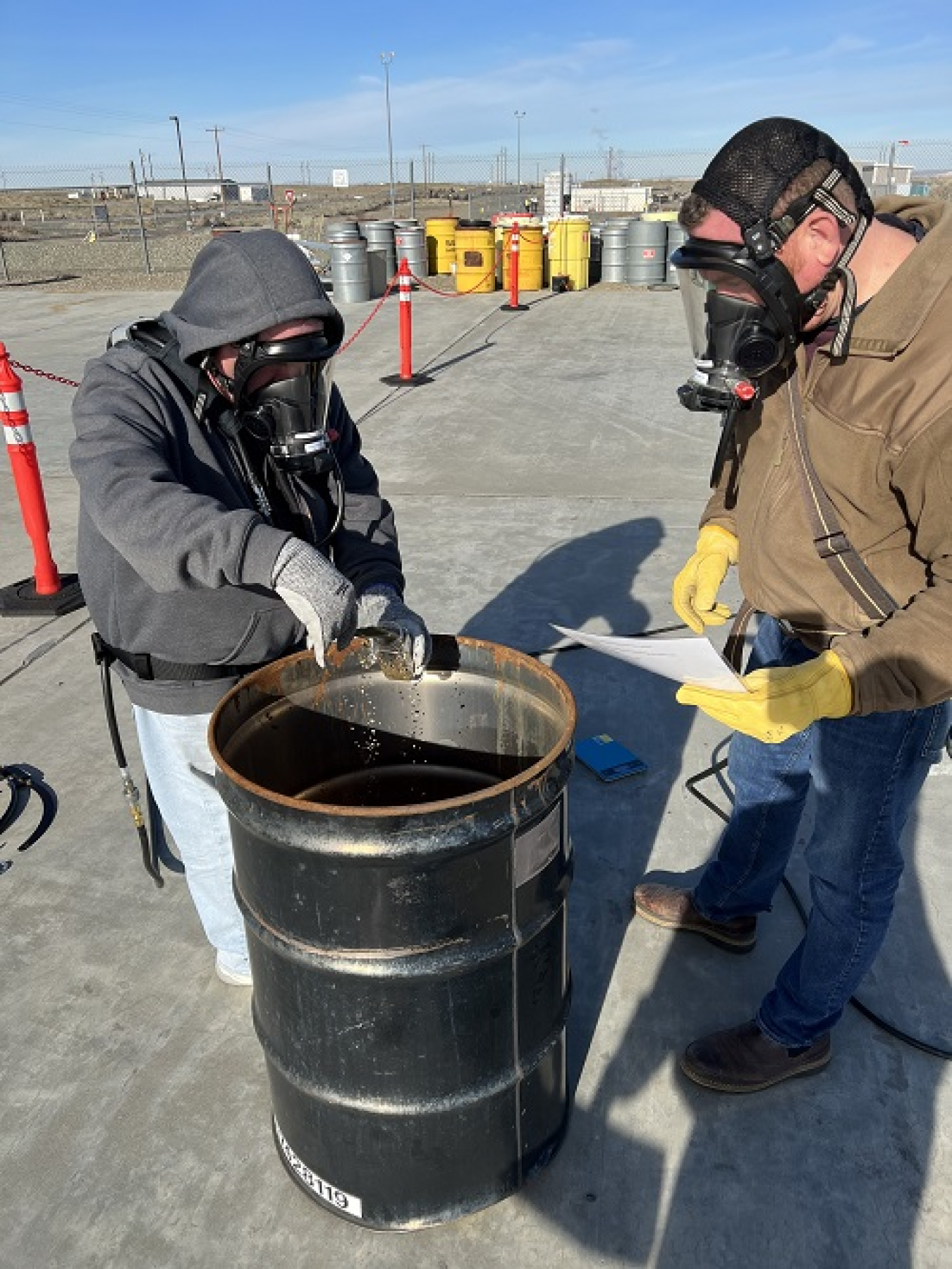 Employees simulate pulling soil samples while wearing supplied air during a respiratory protection training at the Volpentest HAMMER Federal Training Center at the Hanford Site.