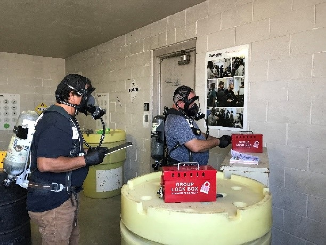 Employees in supplied air equipment work through clues in an “escape room” during respiratory protection training at Hanford’s Volpentest HAMMER Federal Training Center.