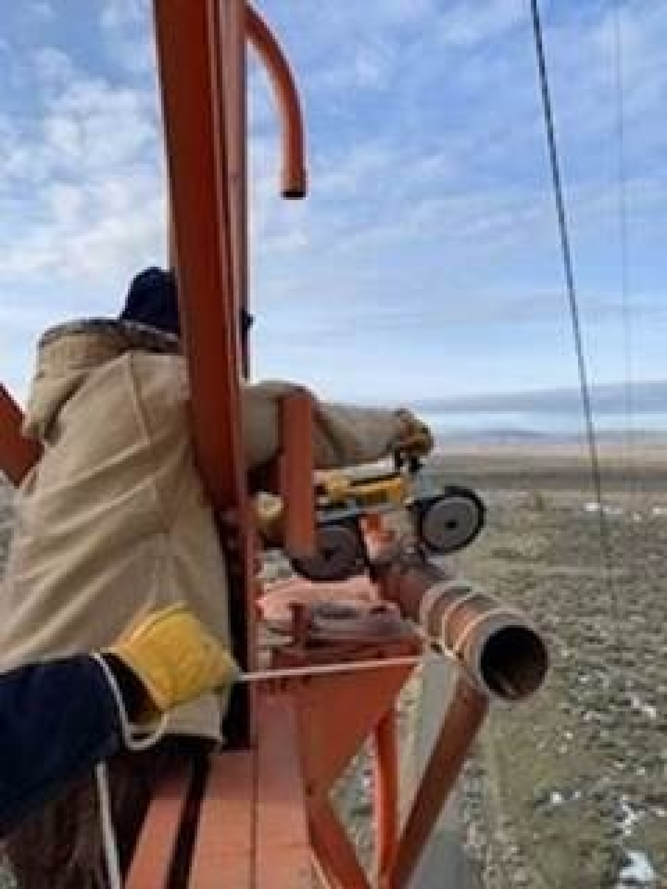 Hanford Mission Integration Solutions pipefitter Shad Smith uses a portable saw to remove unneeded cross arms on a 405-foot meteorological tower, the tallest structure on the Hanford Site.