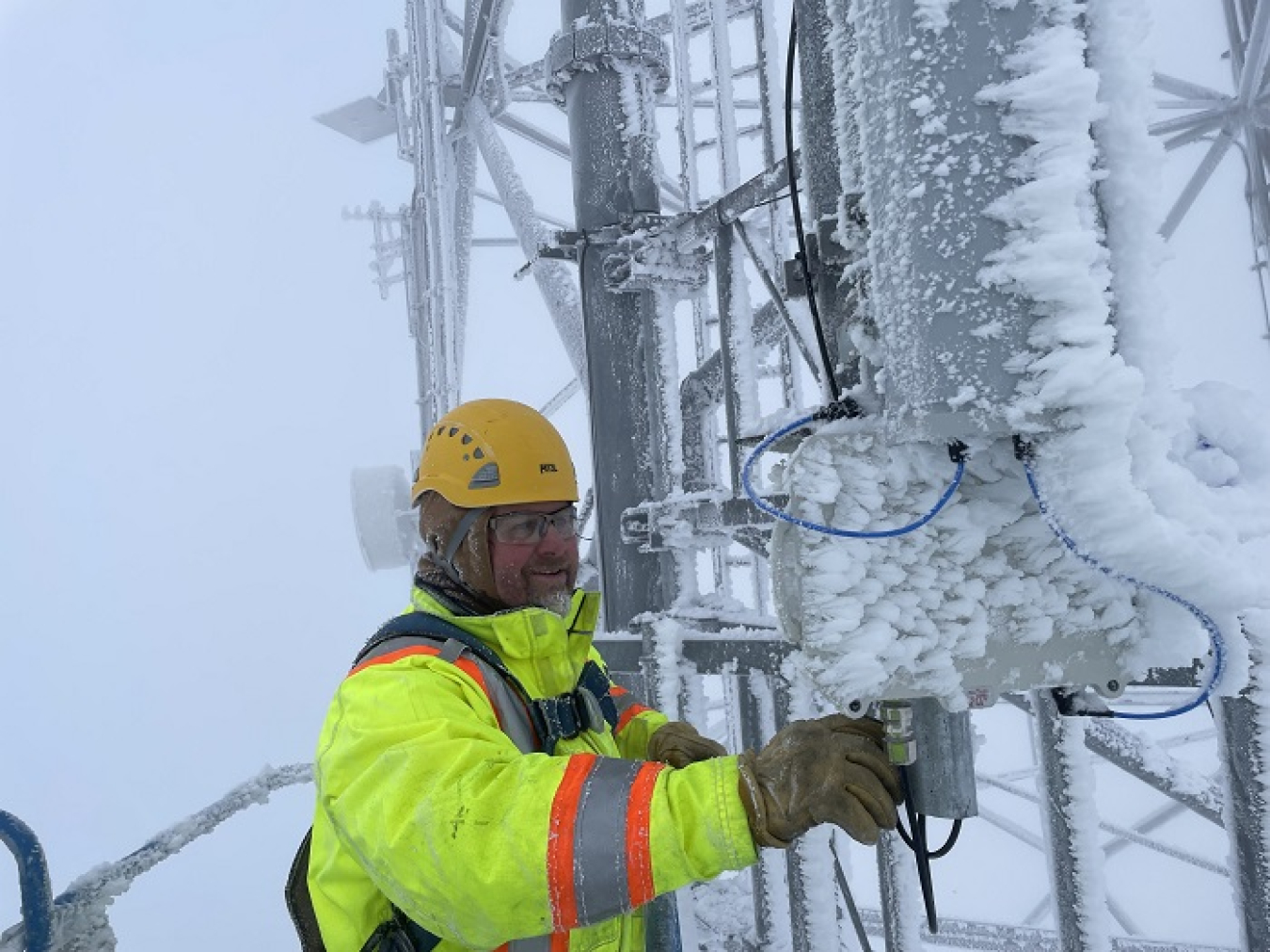 Communications specialist Jason Hammack with Hanford Mission Integration Solutions battles icy conditions while adjusting an antenna on one of the communications towers overlooking the Hanford Site.