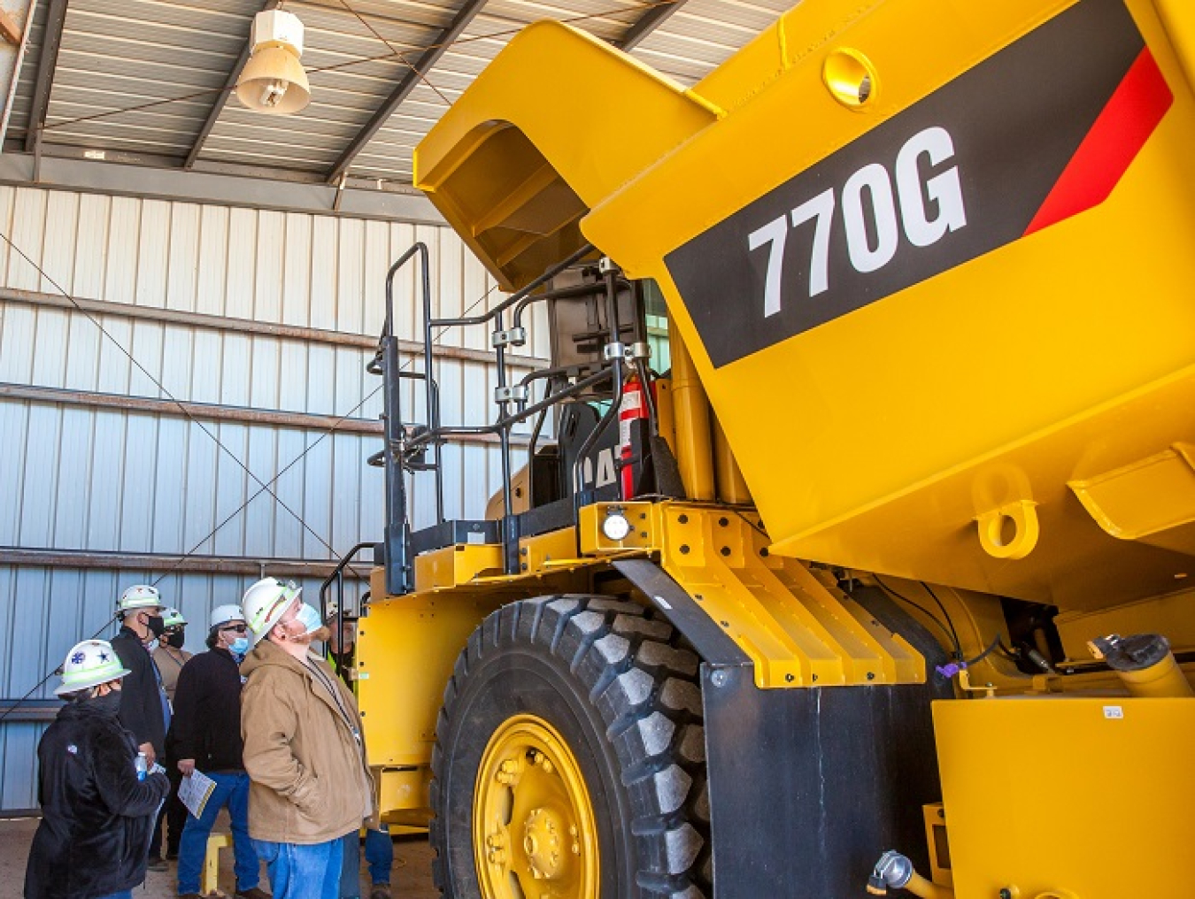 Waste Isolation Pilot Plant (WIPP) hoisting workers, who drive mined salt from WIPP’s underground to surface stockpiles, get their first look at a new truck that will haul salt to areas north of the site. It features diesel technology that reduces soot and other emissions.