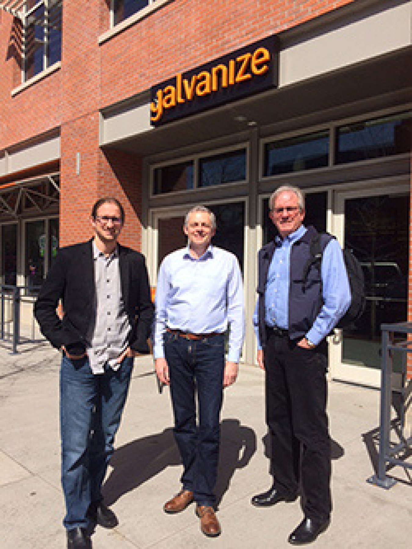 Three men standing outside.