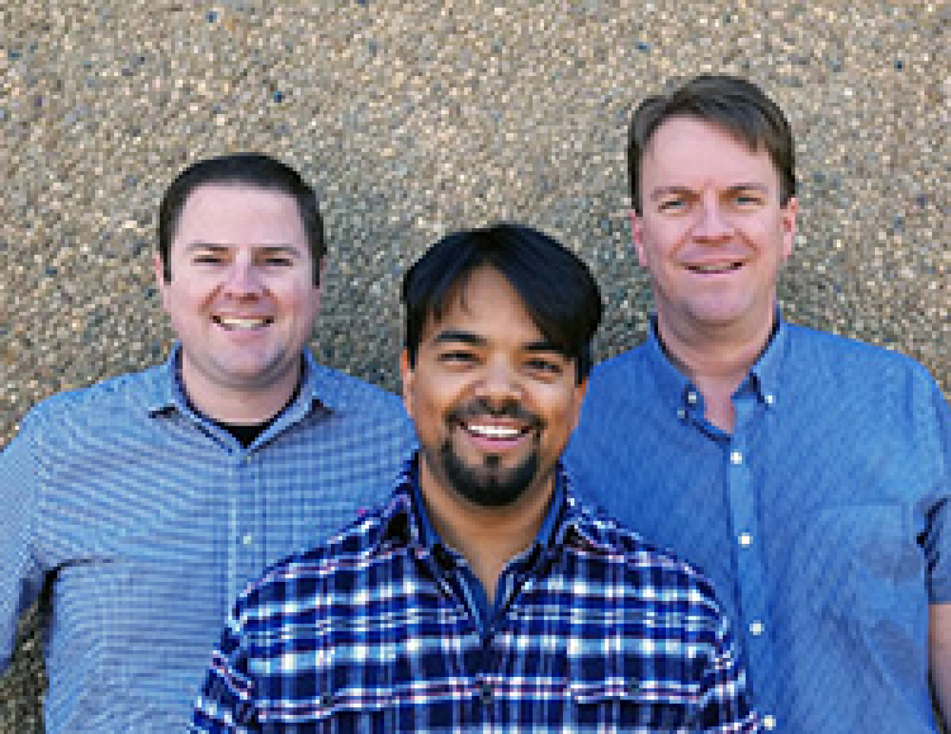 Three men smiling