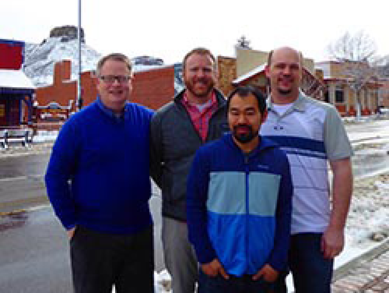 Four men standing outside.