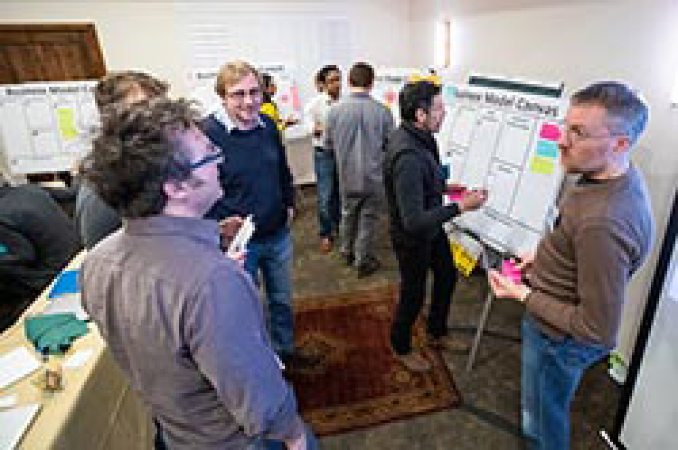 A group of people standing and talking.