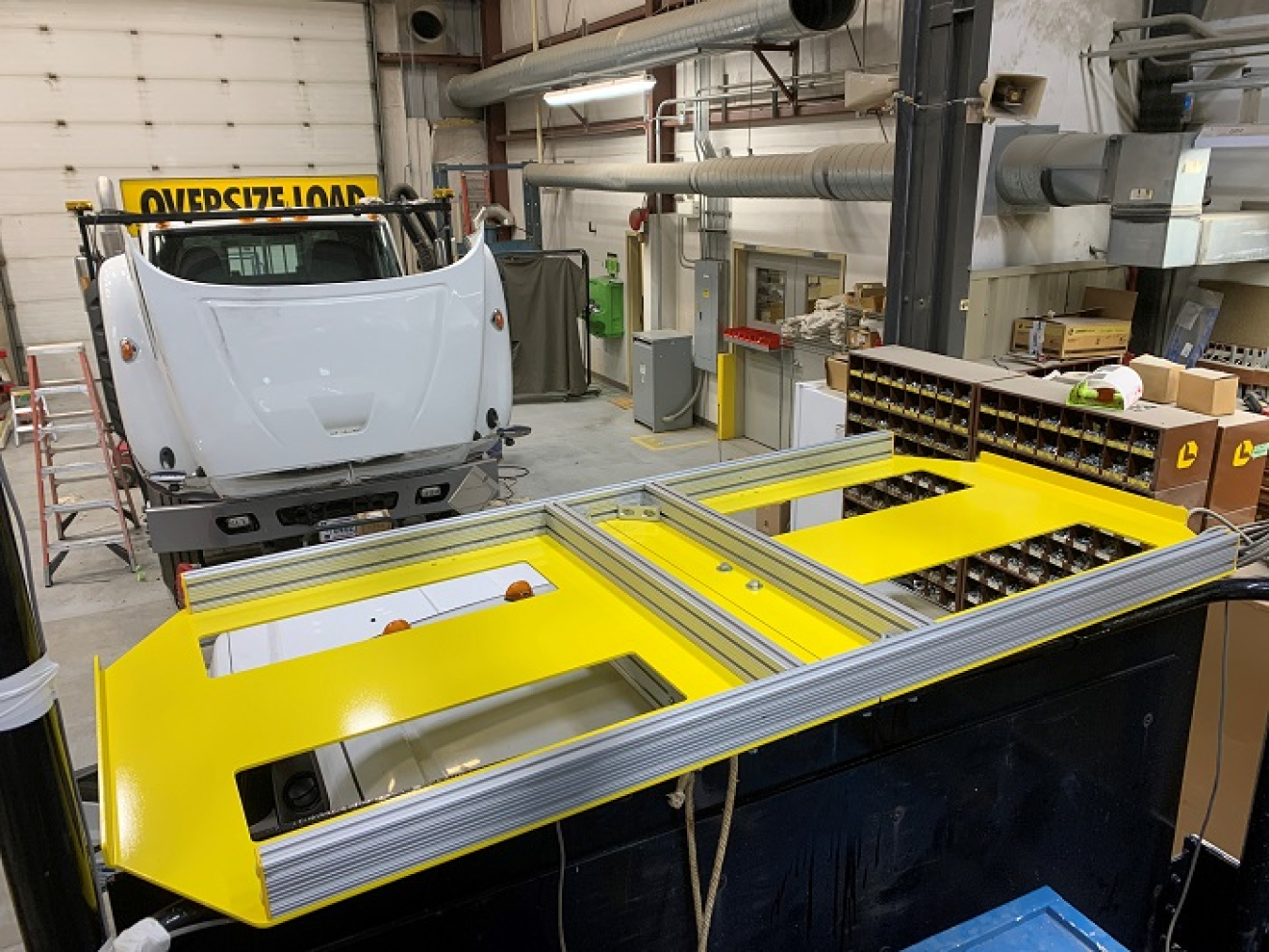 Hanford Mission Integration Solutions mechanics installed a rotating table and electric hoist onto the back of a truck used to transport tank waste samples, improving efficiency and worker safety.